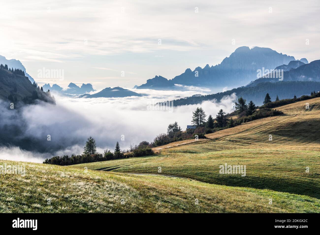 Italy, Veneto, Belluno, Arabba, Livinallongo del Col di Lana, Dolomites. Foggy morning with mountains Pelmo and Civetta in background Stock Photo