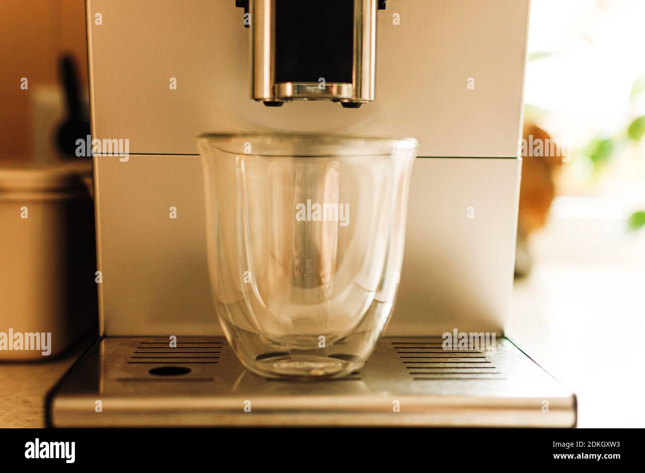 Brewing fresh coffee from the espresso machine. Preparing cappuccino in a glass transparent coffee cup. Stock Photo