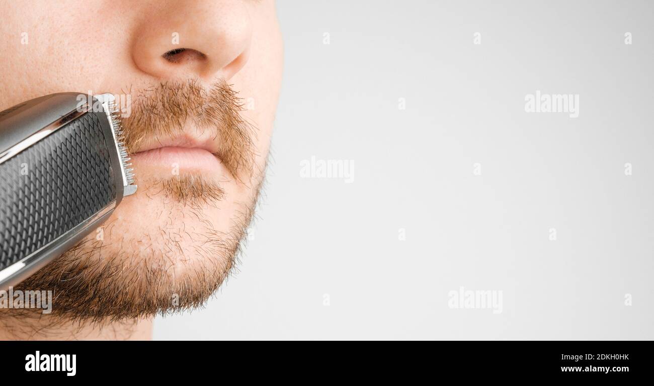 Shaving of mustache with electric razor or trimmer with copy space
