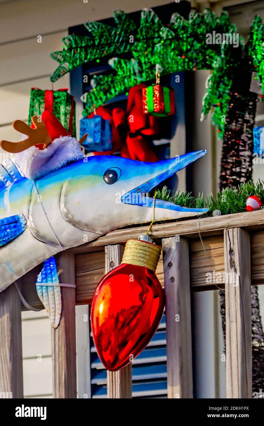 A metal fish decoration wears a Santa Claus hat and holds a Christmas  ornament, Dec. 13, 2020, in Dauphin Island, Alabama Stock Photo - Alamy