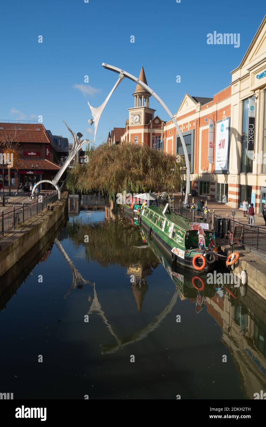 Lincoln City, centre art work, Empowerment sculpture hands across the Witham. Canal boat, long boat, accommodation, shopping area, market square. Stock Photo
