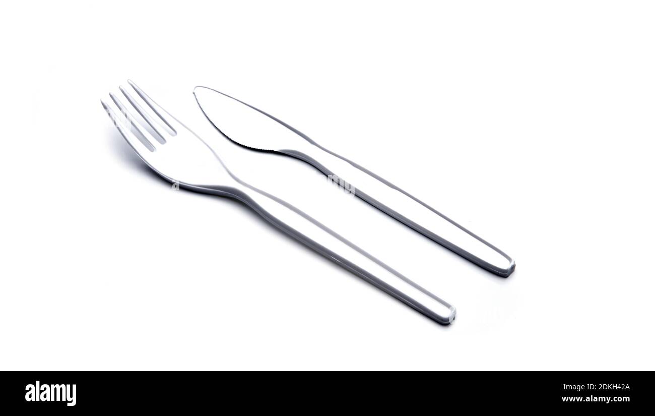White disposable plastic cutlery on a white background Stock Photo