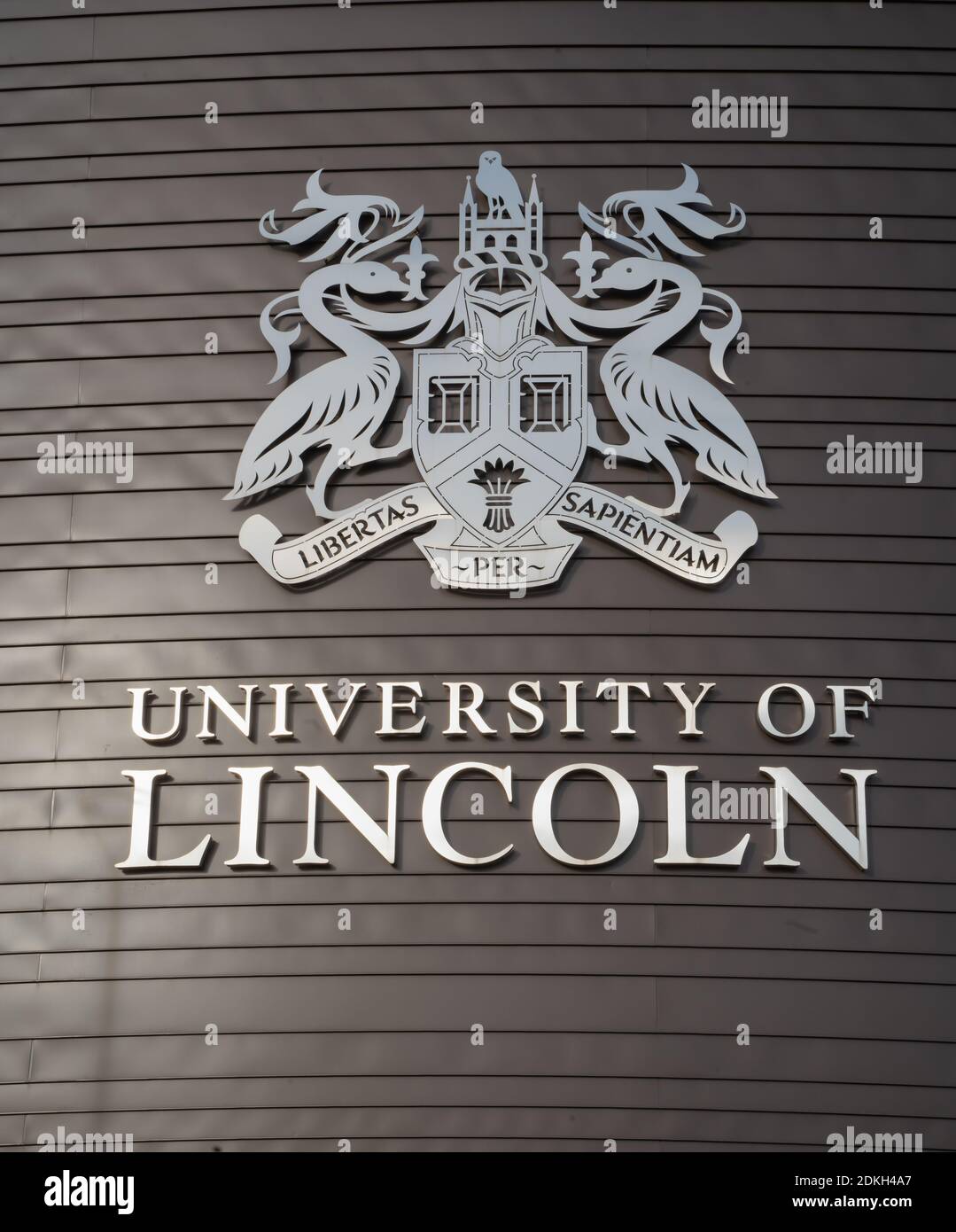 University of Lincoln, new building sign. Coat of arms and motto, Libertas, Sapientiam, Latin Through Wisdom, Liberty, junction of river and canal. Stock Photo