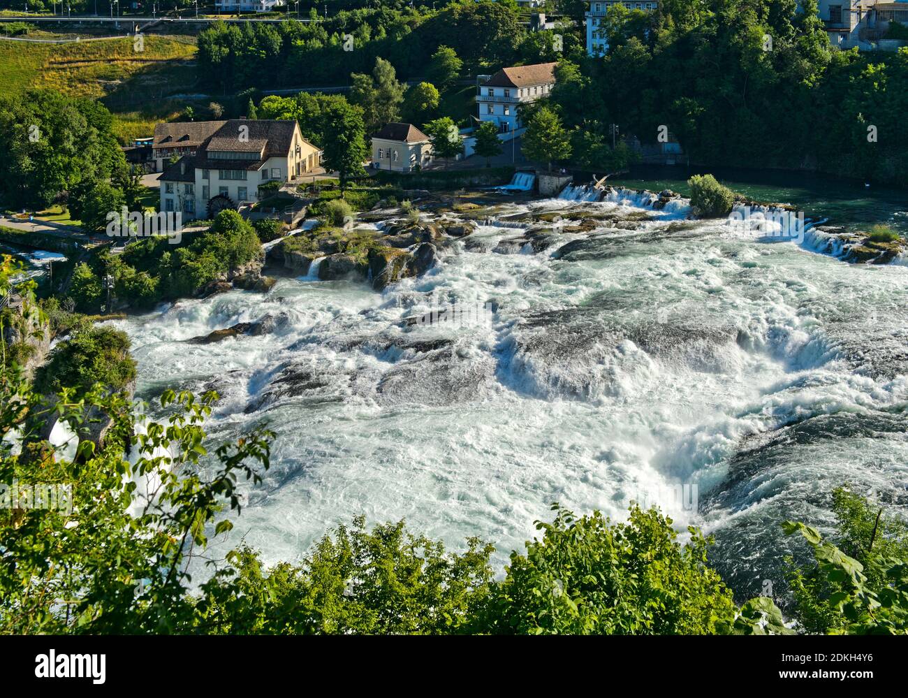 Rushing water masses at the Rhine Falls at the time of the snowmelt in the Alps, Laufen-Uhwiesen near Schaffhausen, Switzerland Stock Photo