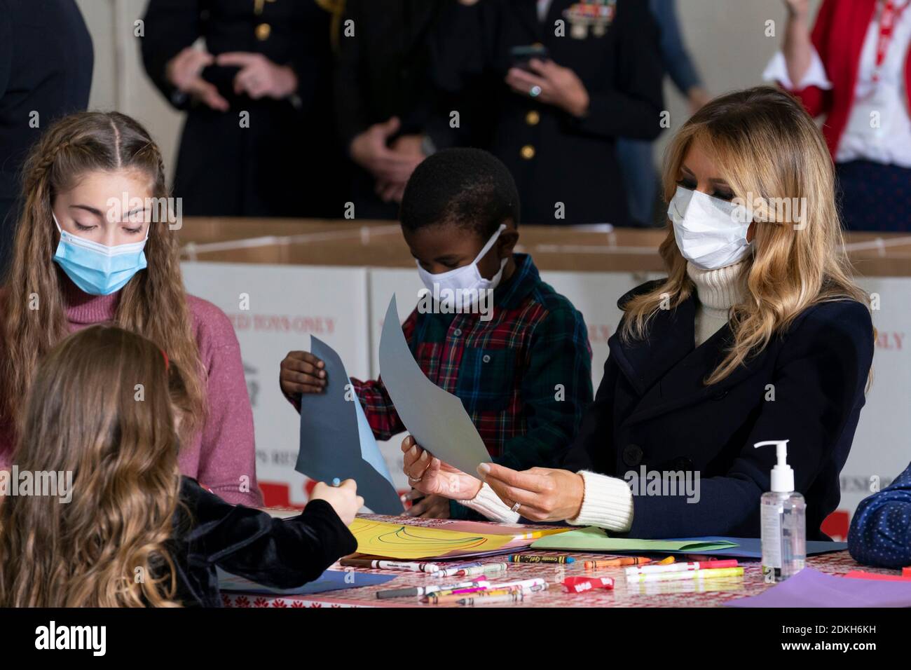 U.S. First Lady Melania Trump works with children to write Christmas cards to the troops during a Toys for Tots Christmas event at Joint Base Anacostia-Bolling December 8, 2020 in Washington, D.C. Stock Photo