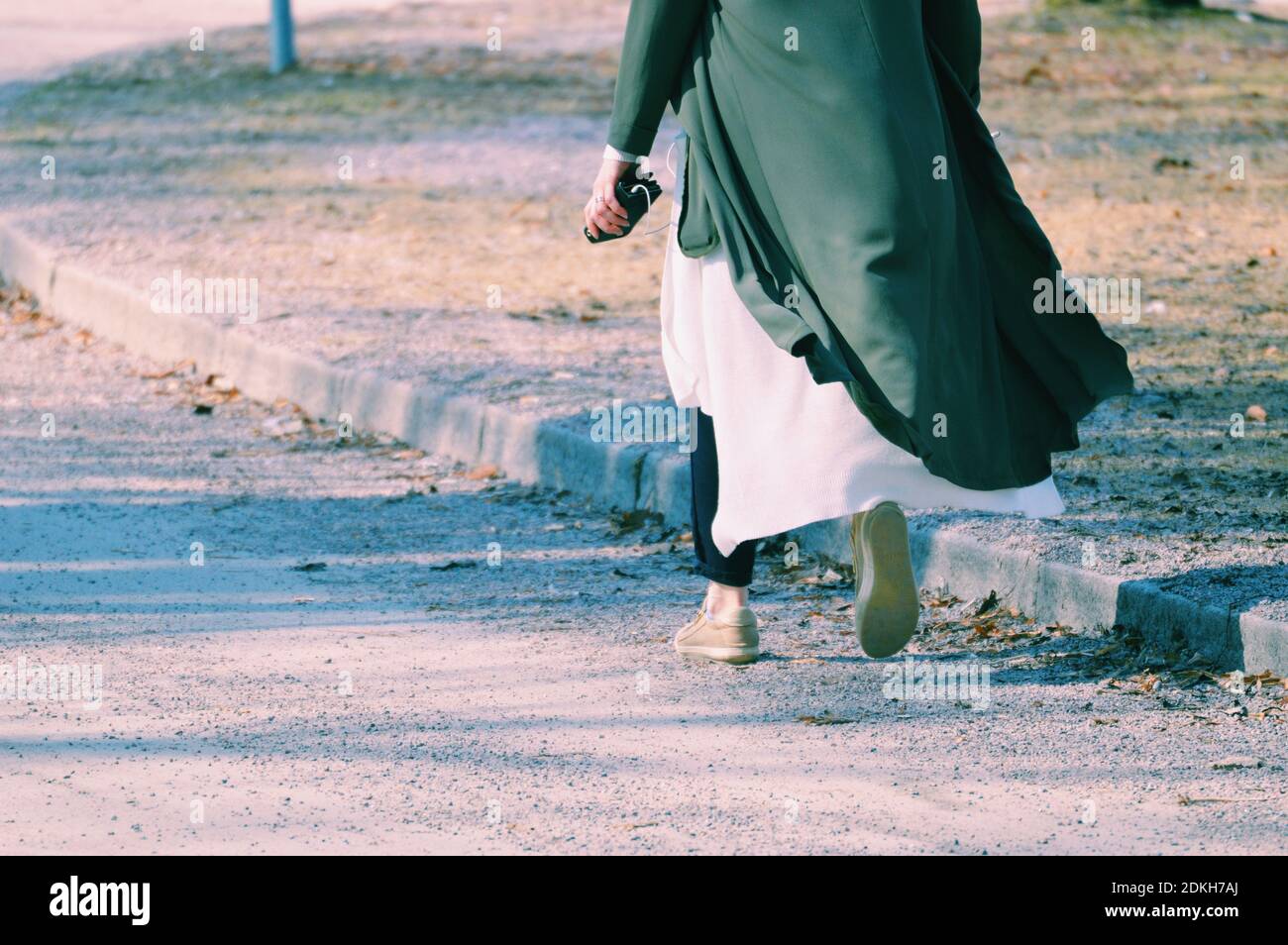 Low Section Of Woman Walking On Road Stock Photo