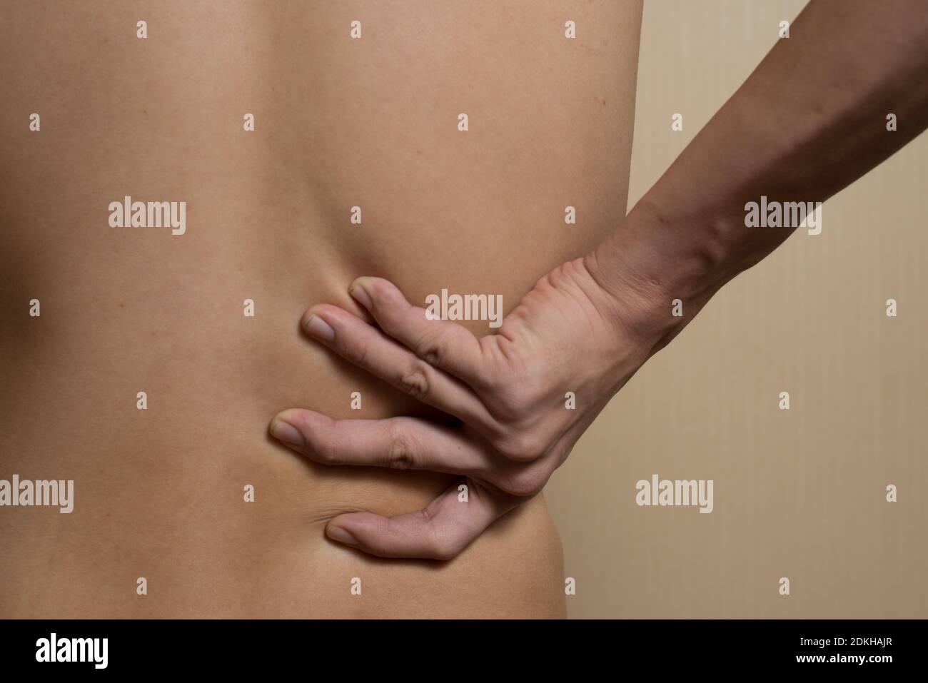 Midsection Of Shirtless Man With Back Pain Stock Photo