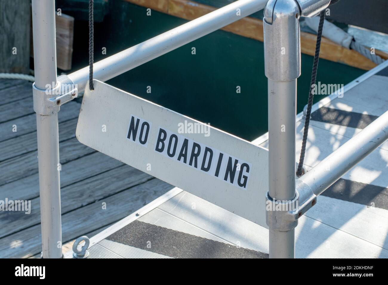 A No Boarding Sign Blocks A Gang Plank To Stop People From Boarding A