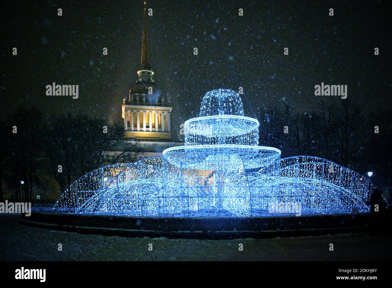 Water Fountain In Illuminated City At Snowy Night Stock Photo - Alamy