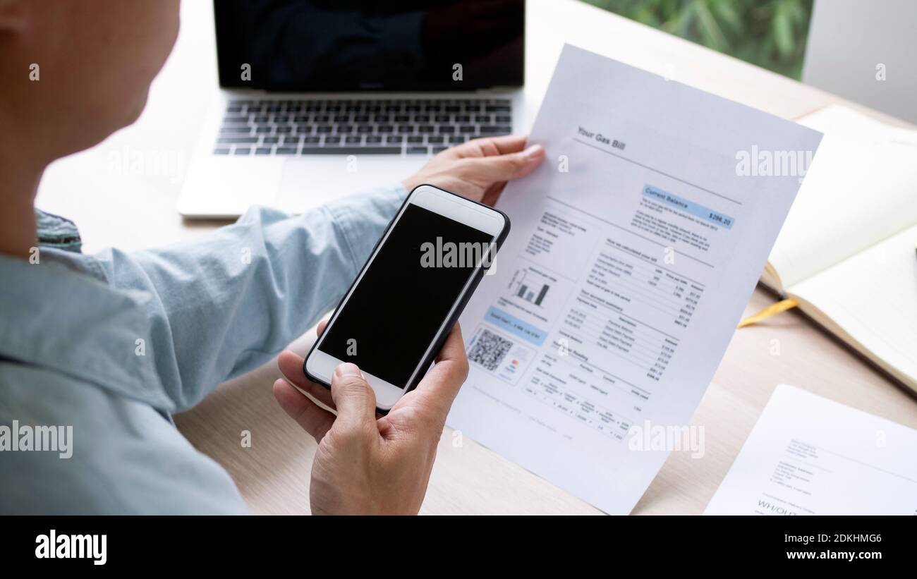 The hand uses the phone to scan the QR code to receive a ...