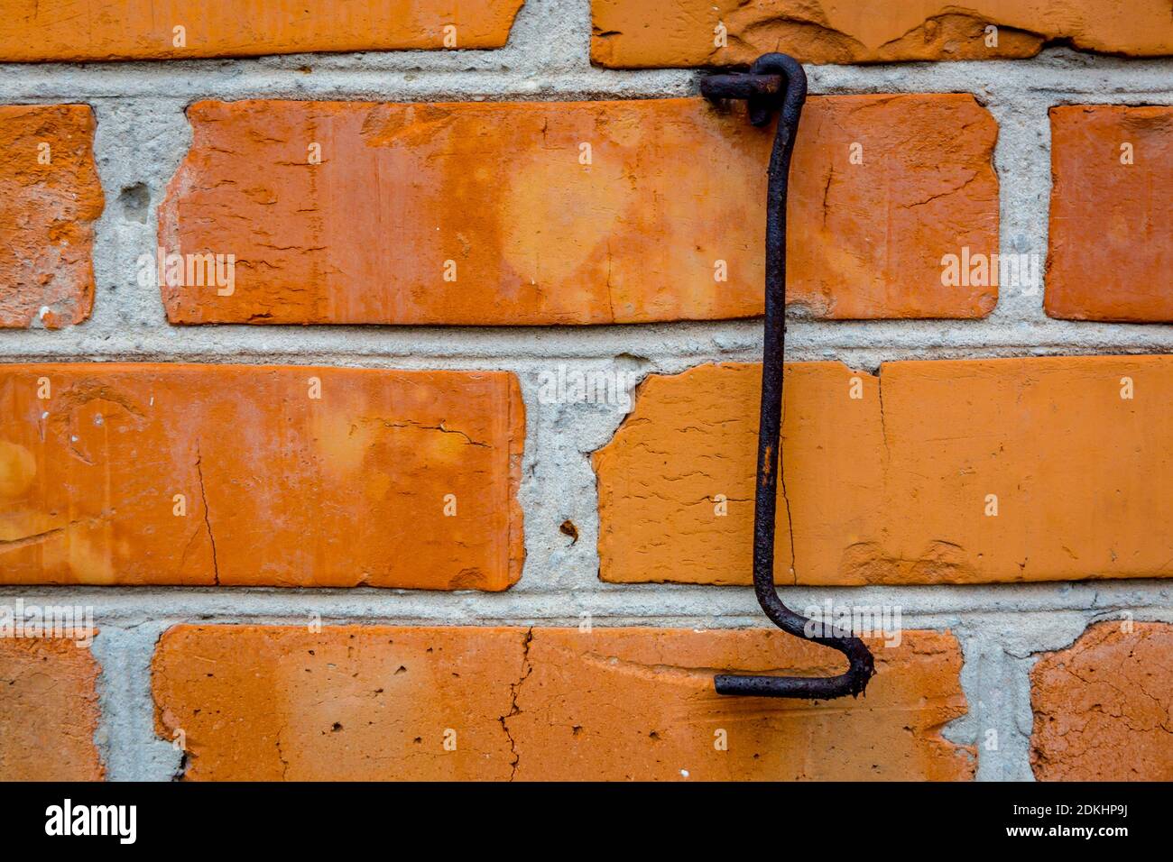 Old rusty hook and red brickwork wall background Stock Photo Alamy