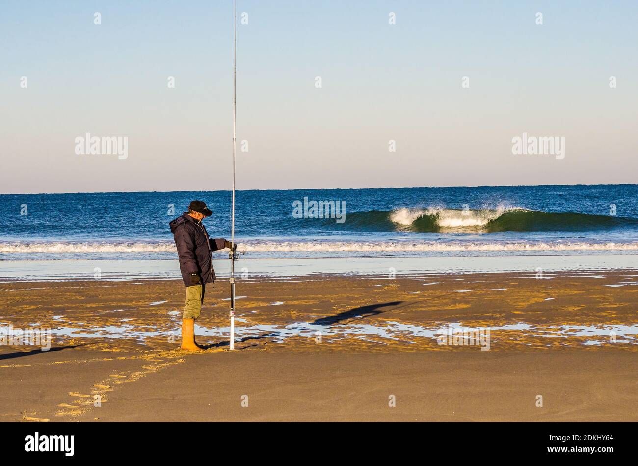 Mimizan Plage, France - April 06, 2020.  Fisherman on the shore of the Atlantic Ocean in the morning Stock Photo