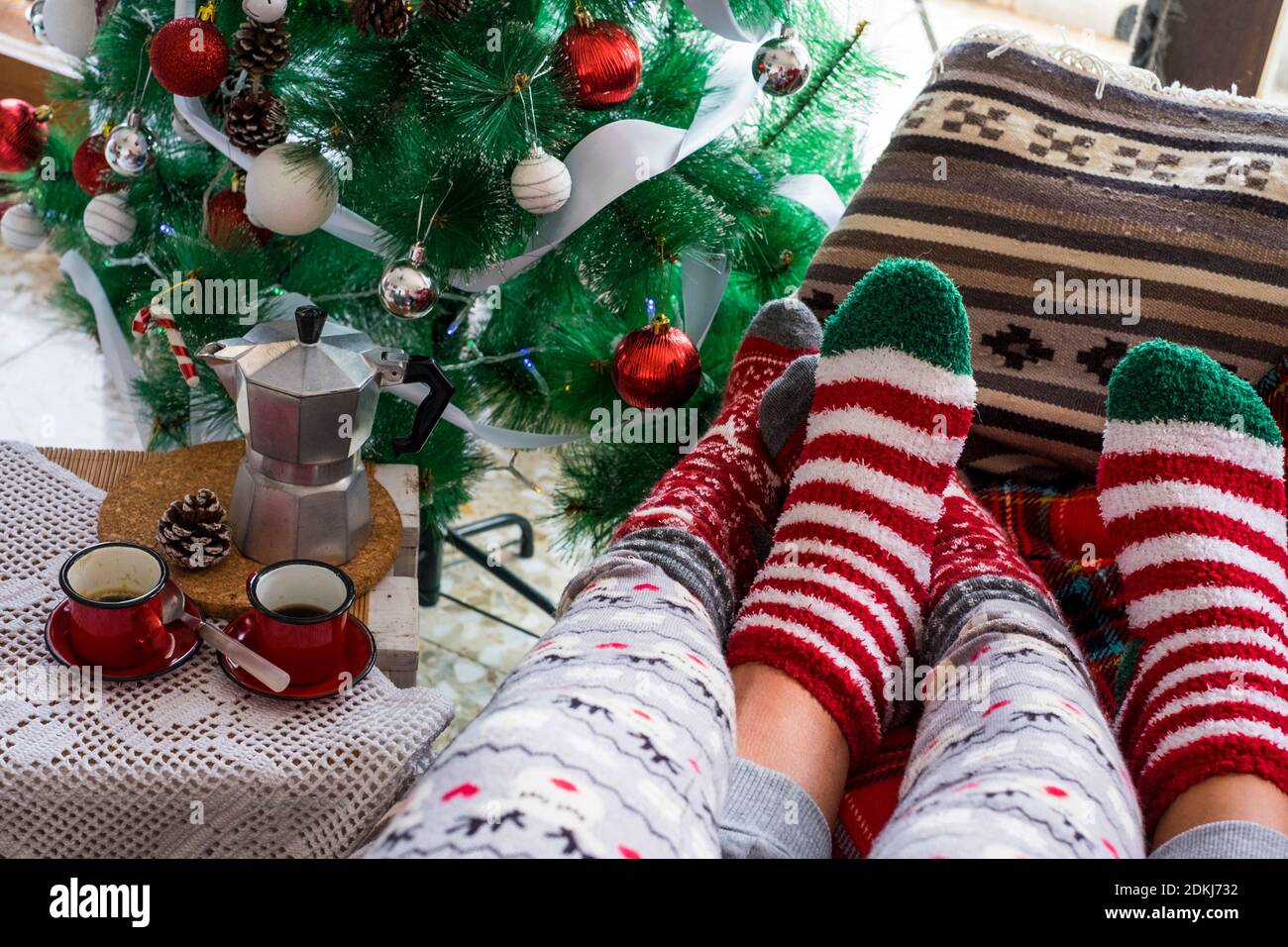 Close up of pair of christmas holidays red socks - concept of love and life together celebrating christmas eve relaxing on the couch - people in love relationship enjoying winter holidays Stock Photo