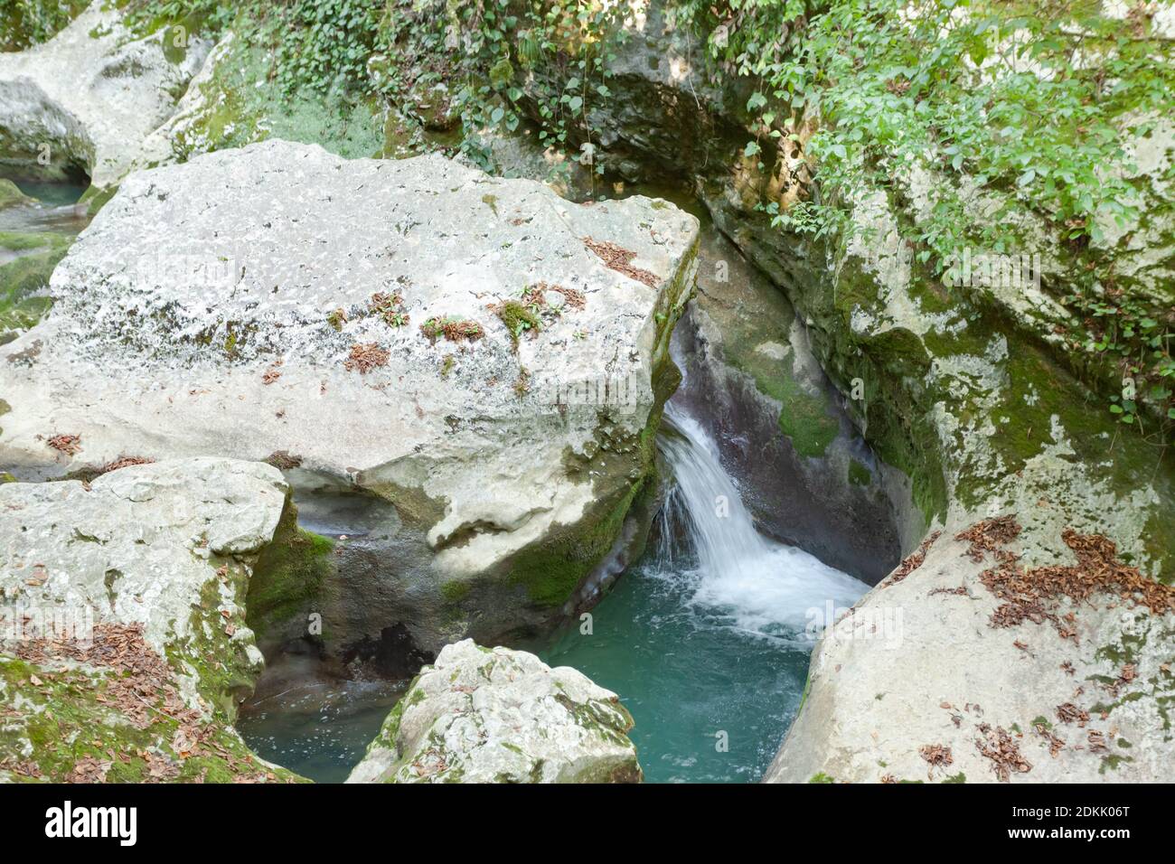 small waterfall among the gray stones Stock Photo