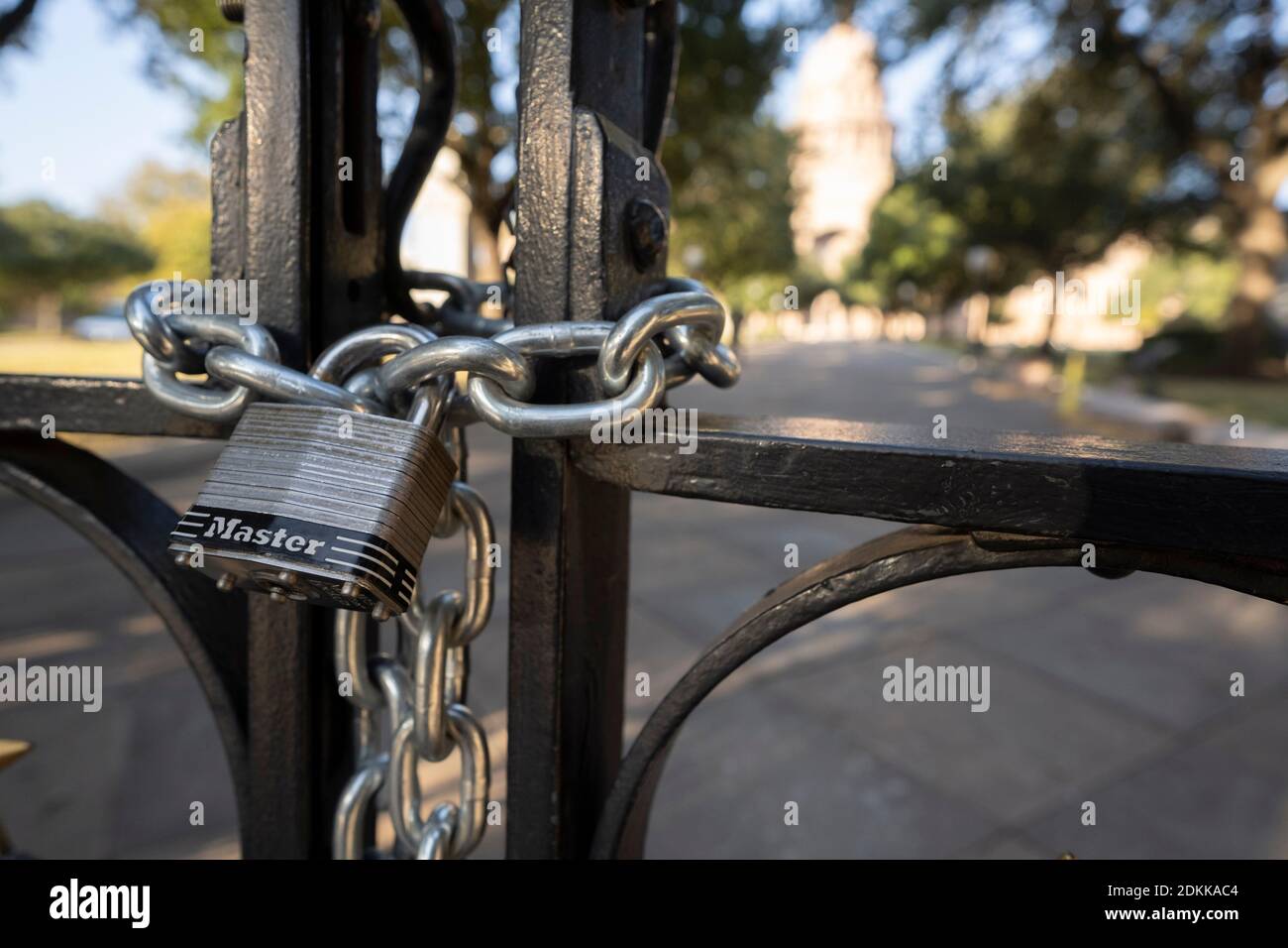 Austin, TX USA December 15, 2020: Locked gates of the Texas Capitol in Austin the evening before Texas Governor Greg Abbott ordered the grounds reopened to the public. The Capitol has been closed for months following vandalism to the grounds and building during protests against police violence after the murder of George Floyd in May, 2020. Credit: Bob Daemmrich/Alamy Live News Stock Photo