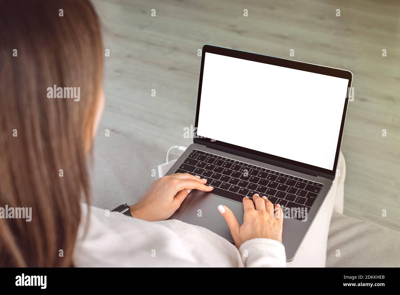 Woman working at home on a laptop. Laptop screen with copy space, mockup Stock Photo