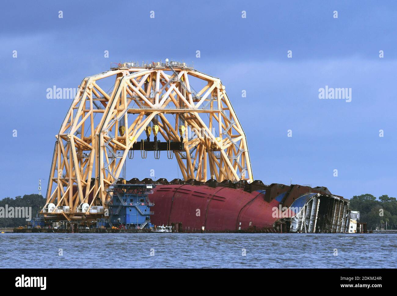 Georgia, USA. 14th Dec, 2020. December 14, 2020 - Jekyll Island, Georgia, United States - The Golden Ray cargo ship lies on its side under a  heavy-lift twin-gantry catamaran, as seen from Driftwood Beach on December 14, 2020 in Jekyll Island, Georgia. A salvage company is cutting the vessel into eight segments, with the bow section having been cut and removed by a barge to be scrapped. The vehicle carrier, loaded with 4200 new cars, capsized in St. Simons Island Sound on September 8, 2019 as it was leaving the Port of Brunswick, Georgia. (Paul Hennessy/Alamy) Credit: Paul Hennessy/Alamy Live  Stock Photo
