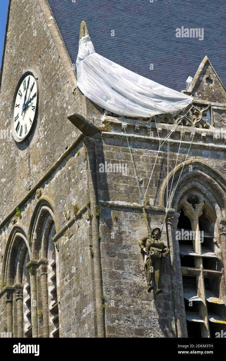 A replica paratrooper hangs on the church tower at Sainte-Mere-Eglise ...