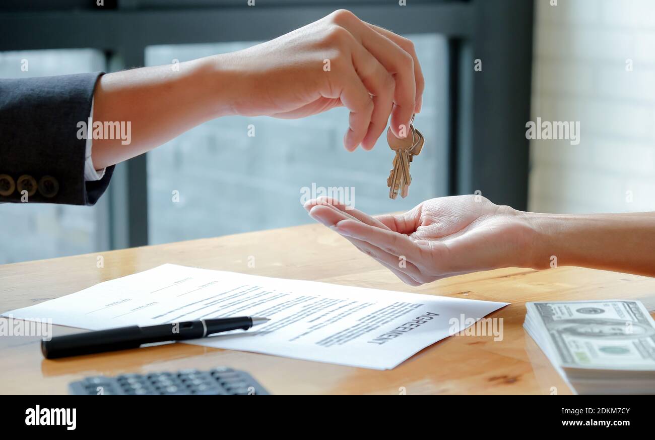 Cropped Image Of Hand Holding Paper On Table Stock Photo