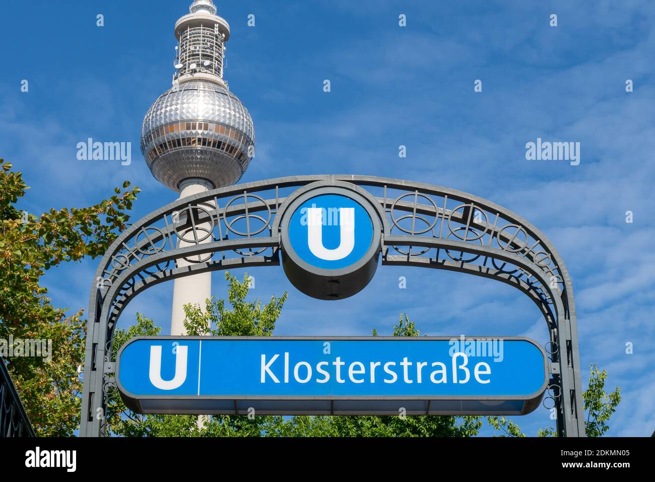 Low Angle View Of Information Sign With Text Against Berlin Fernsehturm And Blue Sky Stock Photo