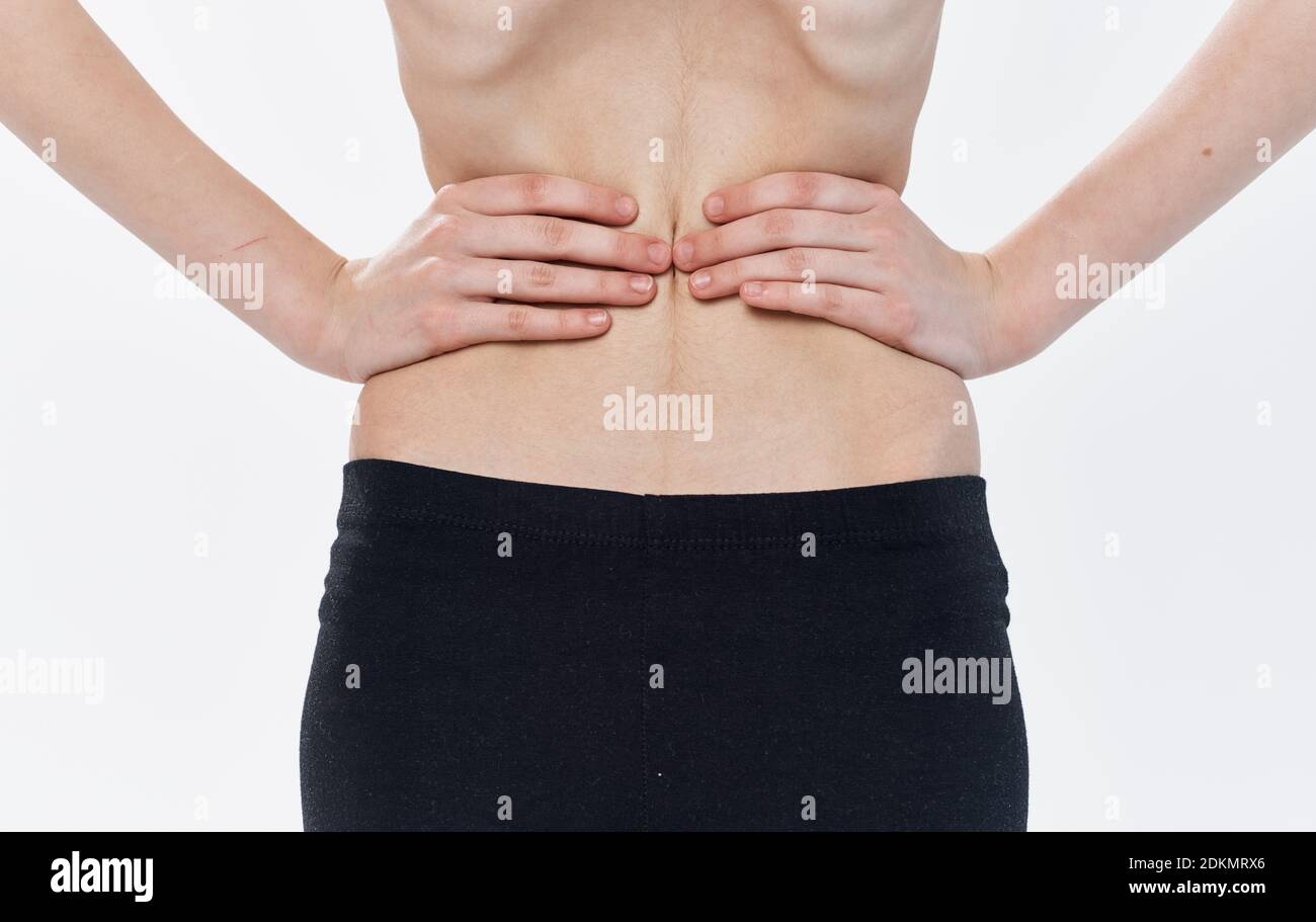 Rear view of the back of a thin woman showing the ribs and spine
