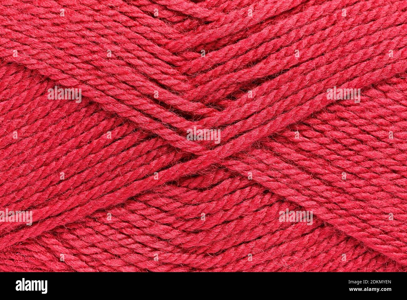 Texture of a skein of crimson woolen thread closeup Stock Photo
