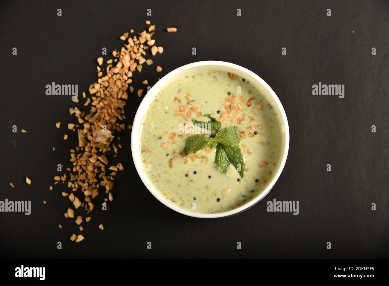 Raita is an Indian dish made with yogurt, spice powders, herbs & veggies like onions, cucumbers & carrots Stock Photo