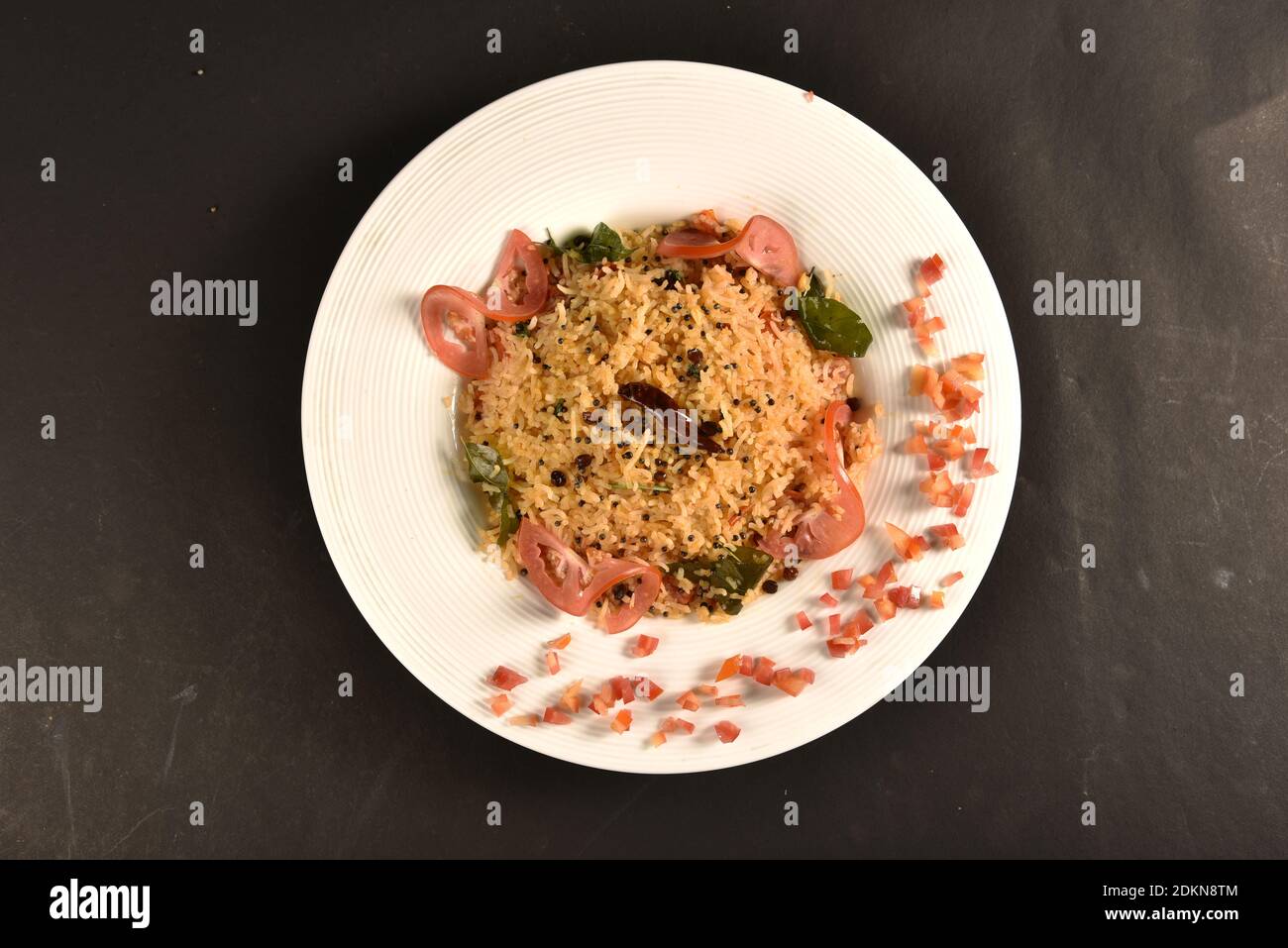 Chitranna is a rice-based dish widely prepared in South India. It is prepared by mixing cooked rice with a special seasoning called Oggarane or Gojju Stock Photo