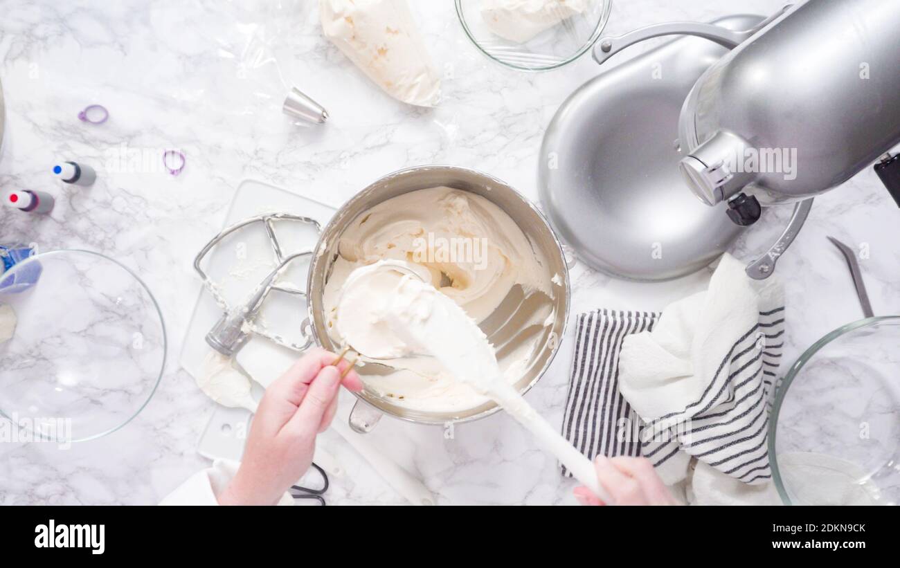 Mixing ingredients in standing kitchen mixer to make buttercream frosting Stock Photo Alamy