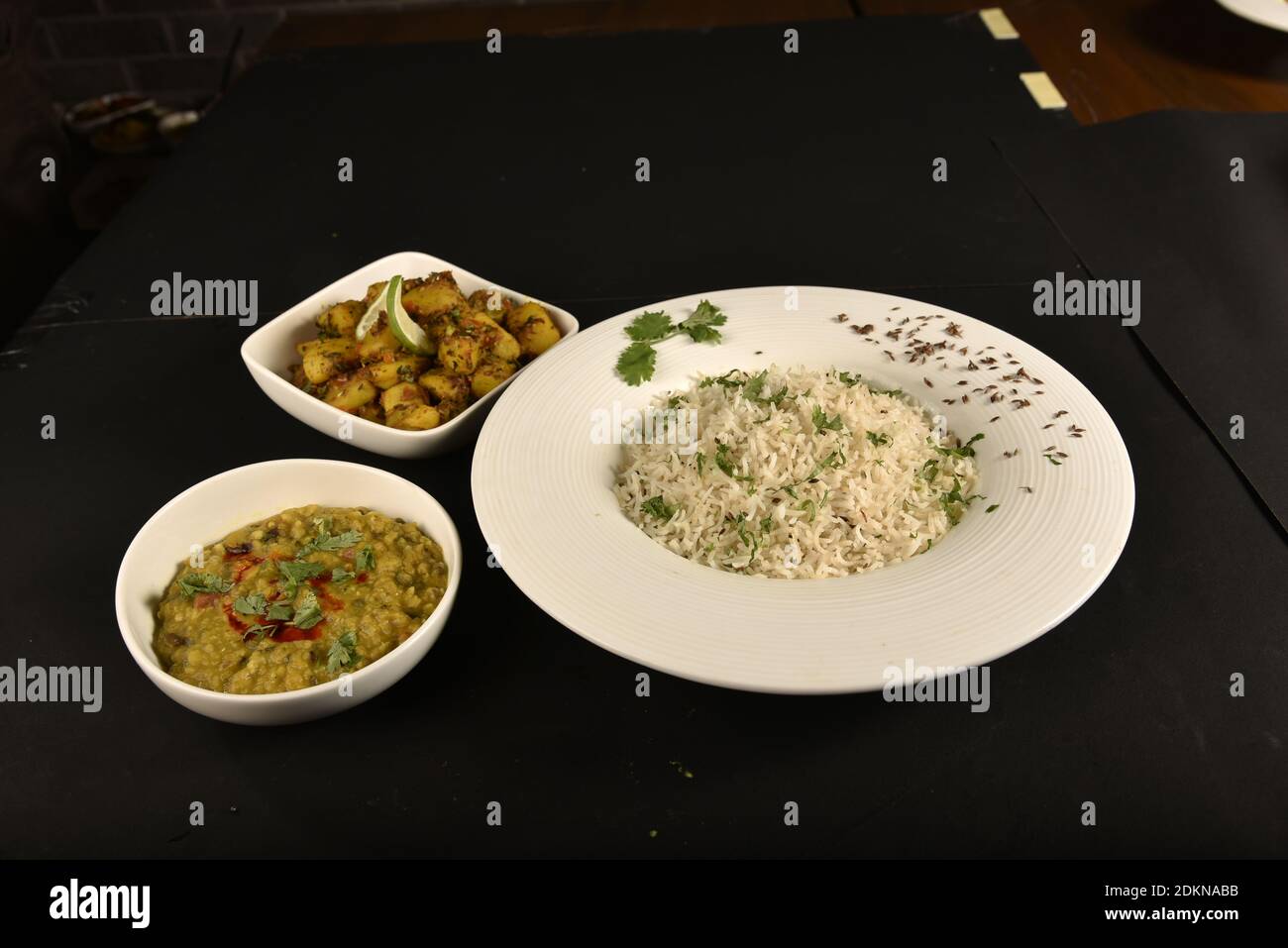 jeera rice served with potato chaat and dal fry Stock Photo Alamy