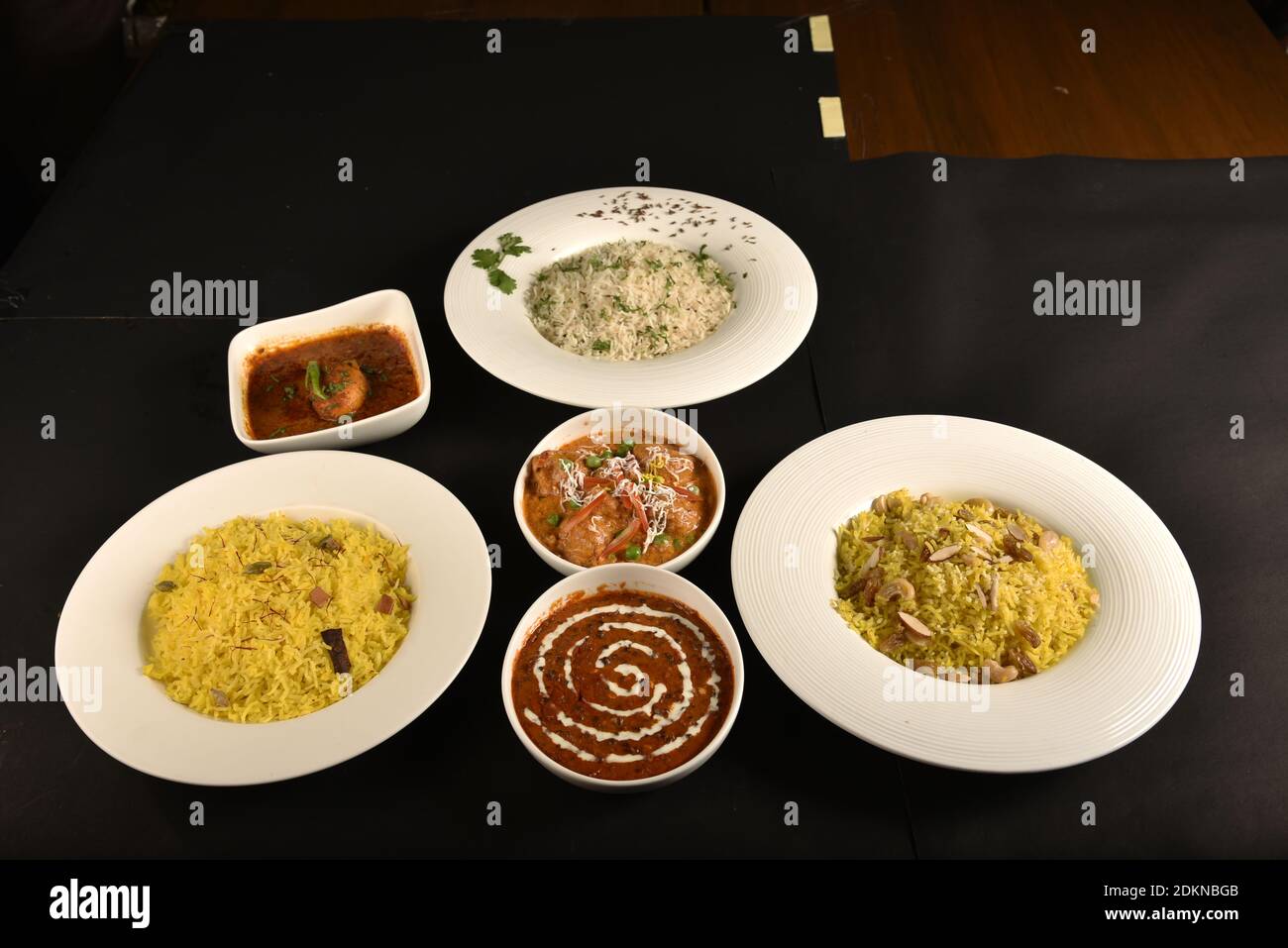 three rice dishes of different flavours served in one table with spicy dal fry,egg curry and paneer Stock Photo