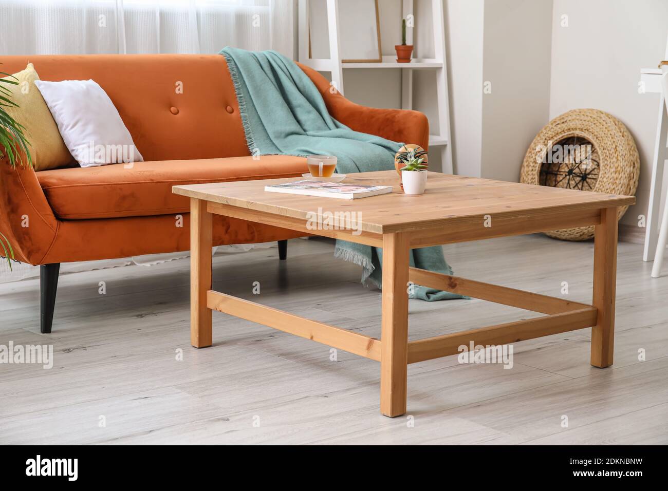 Stylish interior of modern living room with table Stock Photo - Alamy