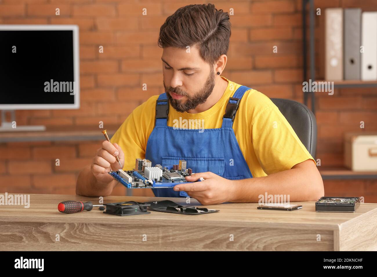 Technician repairing computer in service center Stock Photo - Alamy