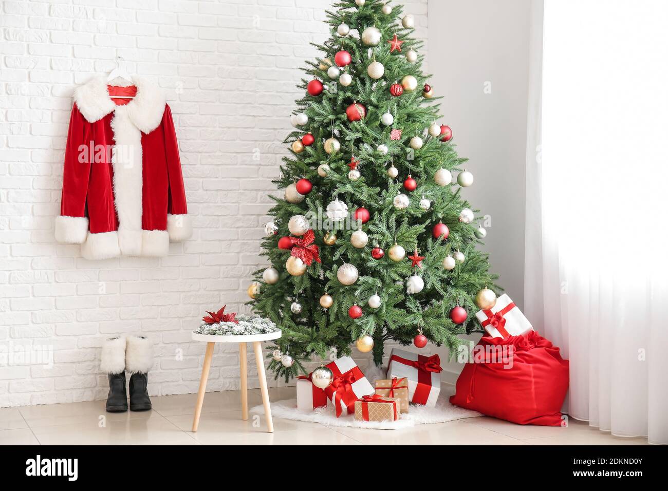 Interior of living room with Santa costume, gifts and beautiful ...