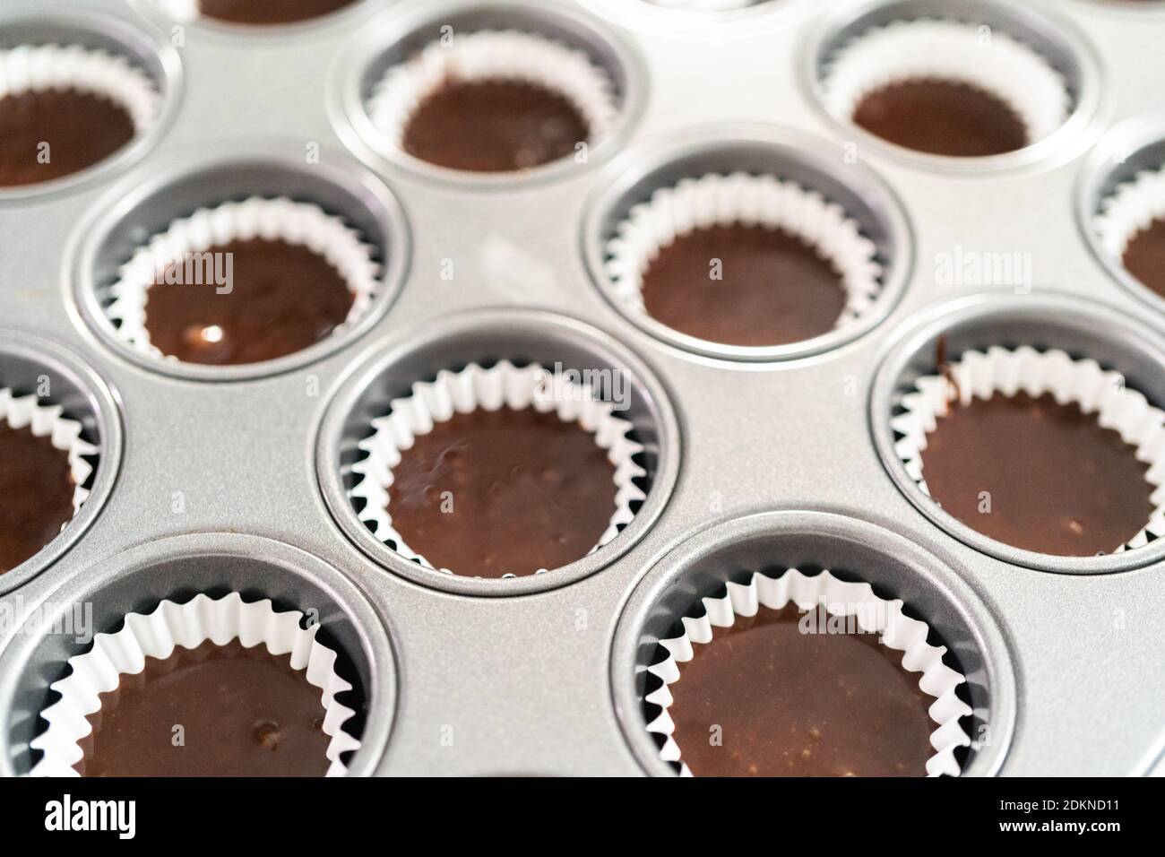 Baking chocolate mini cupcakes in cupcake pan Stock Photo Alamy