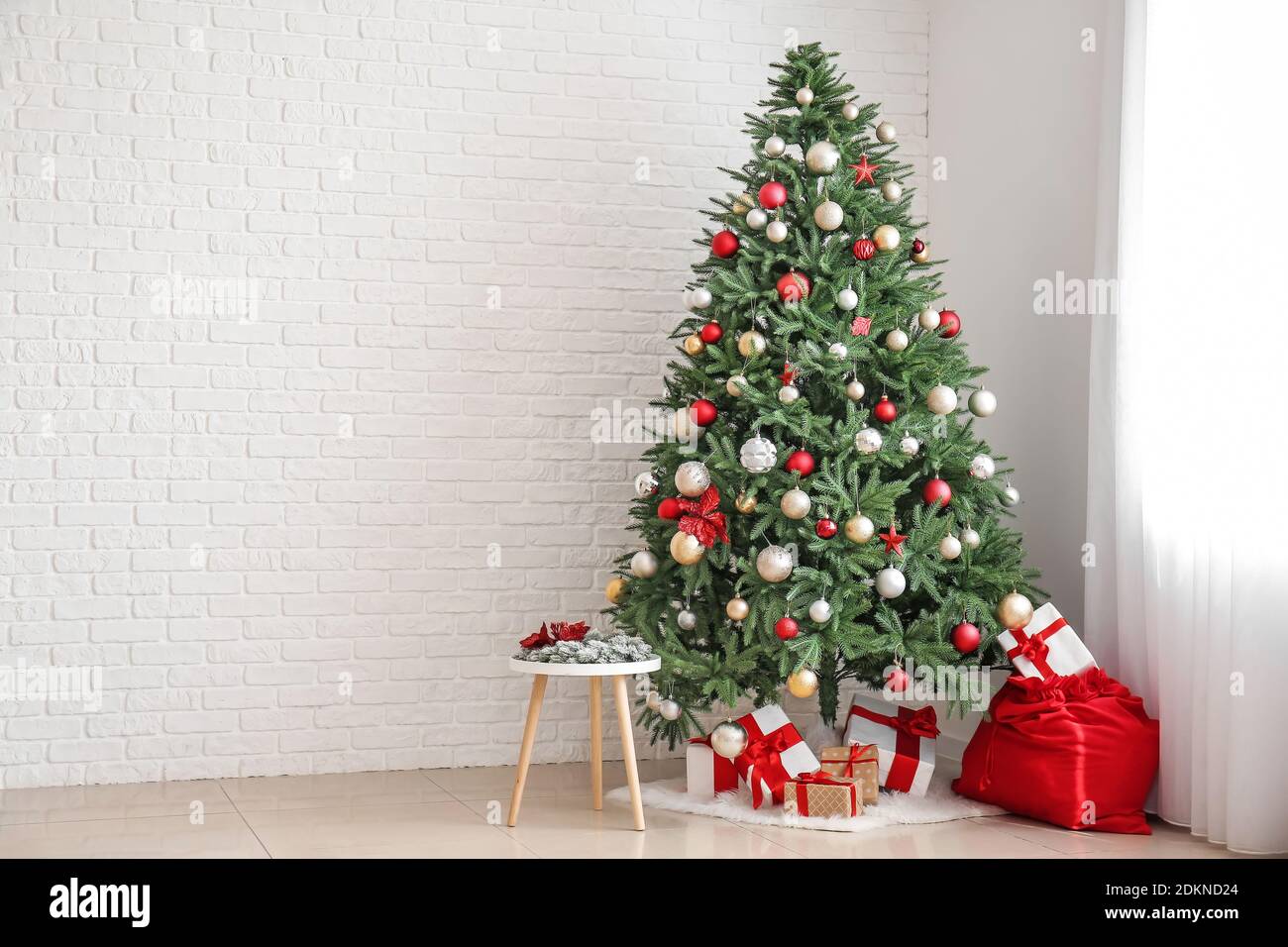 Interior of living room with Santa bag, gifts and beautiful Christmas tree Stock Photo