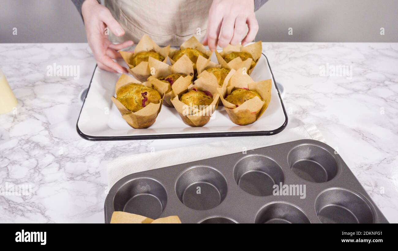 Step by step. Cooling freshly baked cranberry muffins. Stock Photo