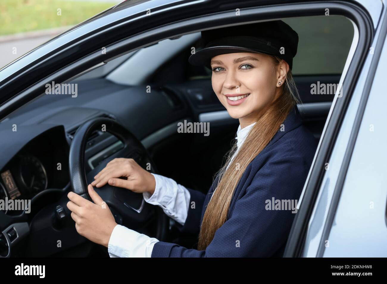 Beautiful chauffeur driving luxury car Stock Photo Alamy