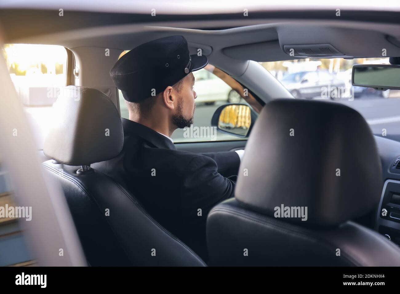 https://c8.alamy.com/comp/2DKNHX4/handsome-chauffeur-driving-luxury-car-2DKNHX4.jpg