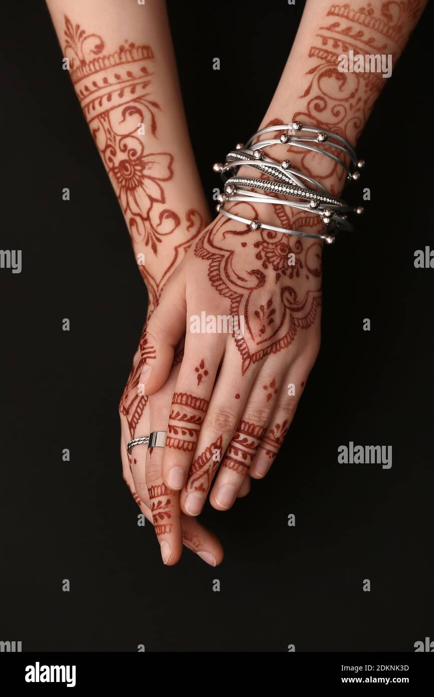 Beautiful female hands with henna tattoo on dark background Stock ...