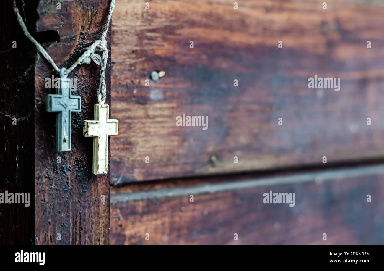 Two Christian crosses hanging near a wooden wall Stock Photo Alamy