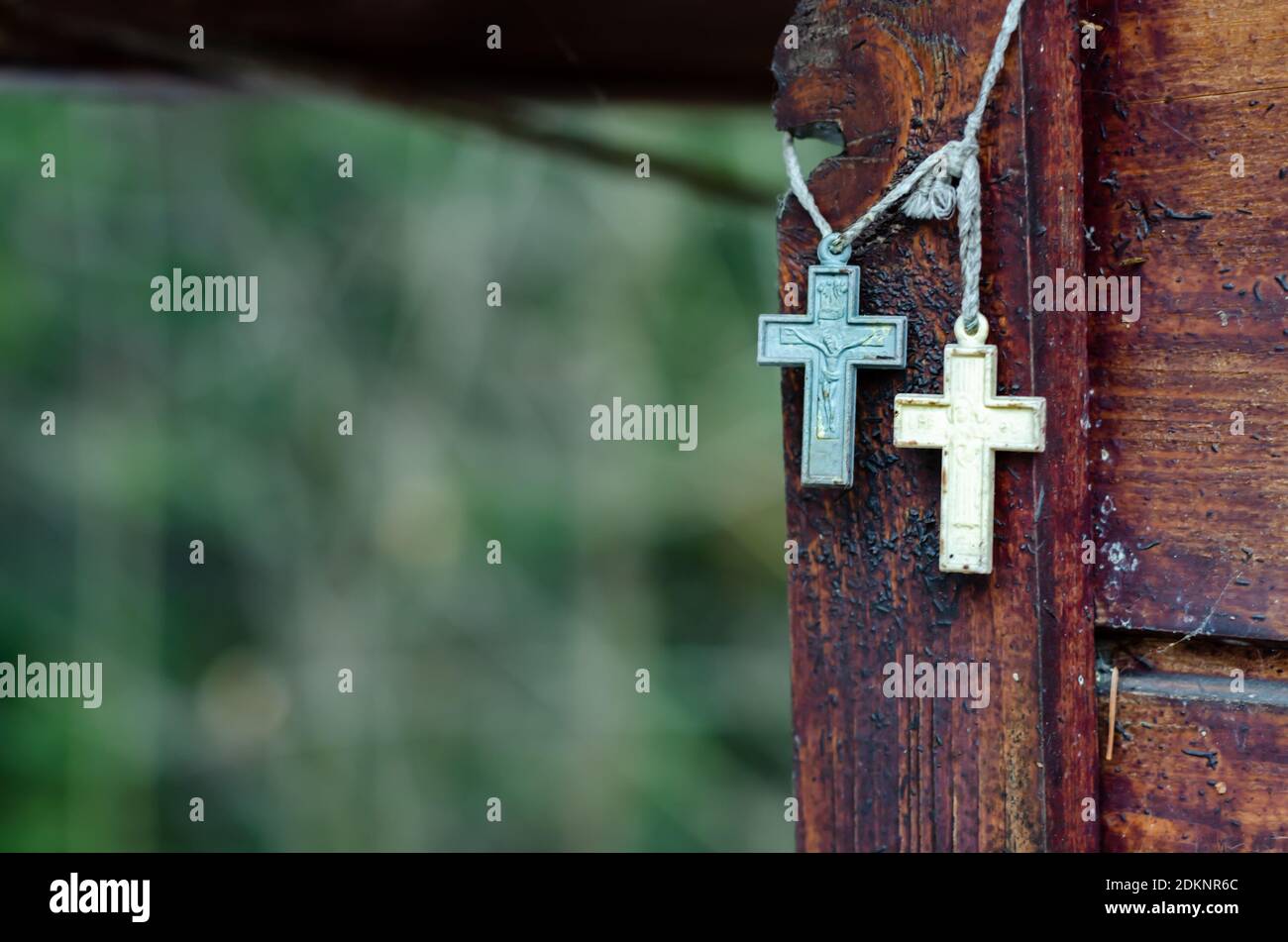 Two Christian crosses hanging near a wooden wall Stock Photo Alamy