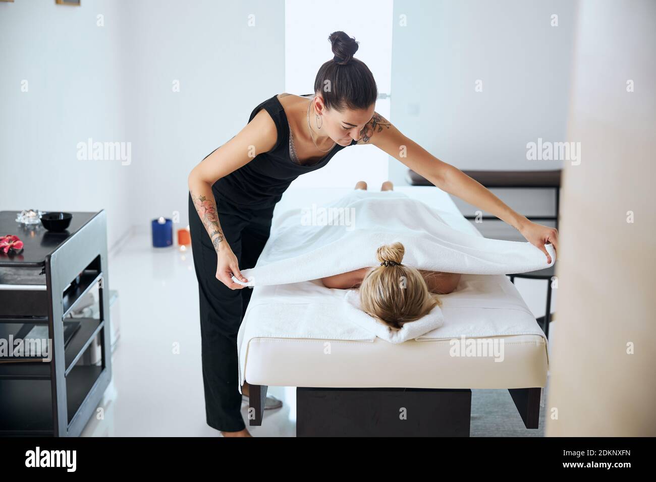 Beautiful massage therapist finished aroma treatment in spa center