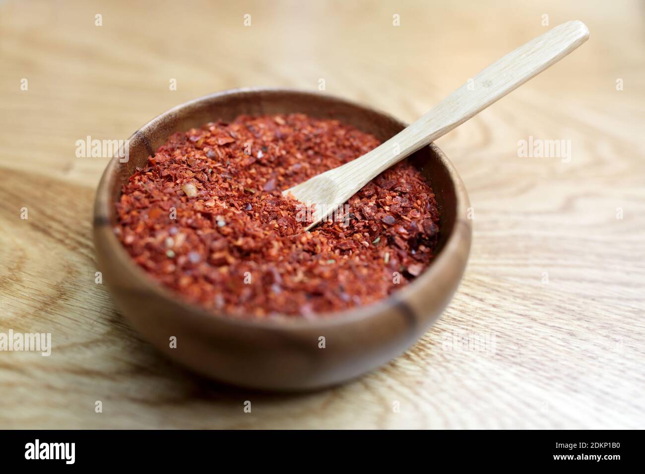 Red pepper in a wooden cup on a table Stock Photo