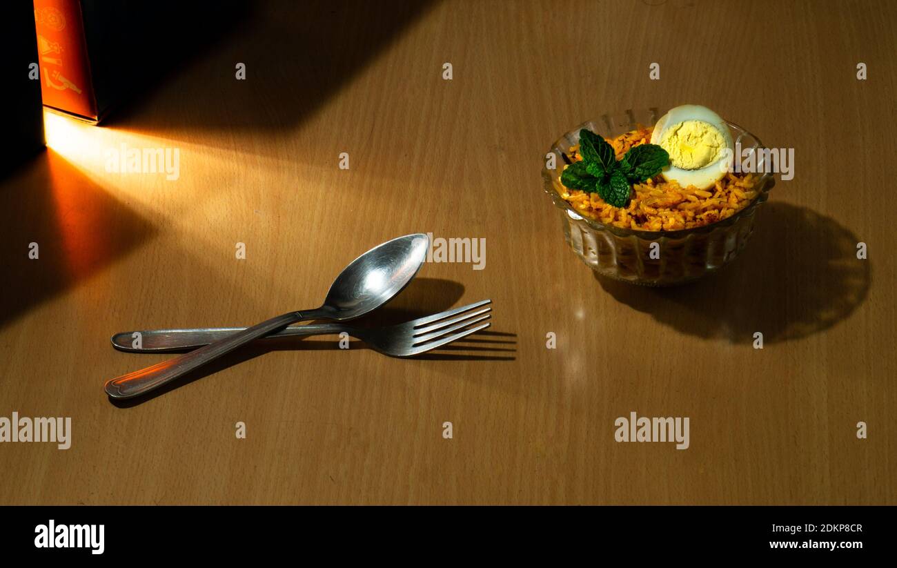 Tasty homemade egg biriyani in a bowl on the wooden table Stock Photo