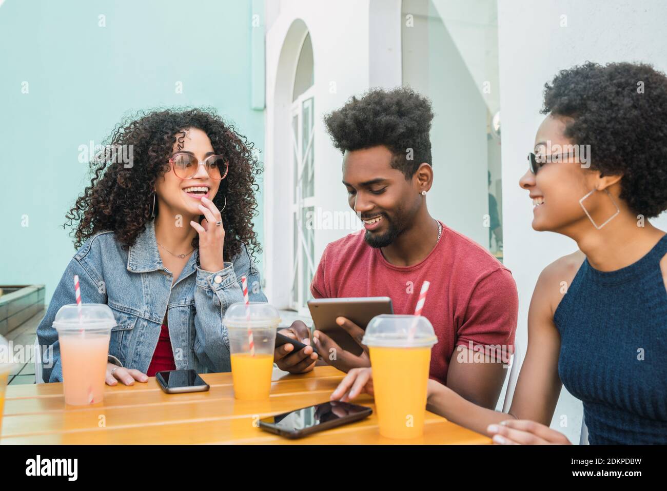 Afro friends having fun together while drinking fruit juice Stock Photo ...