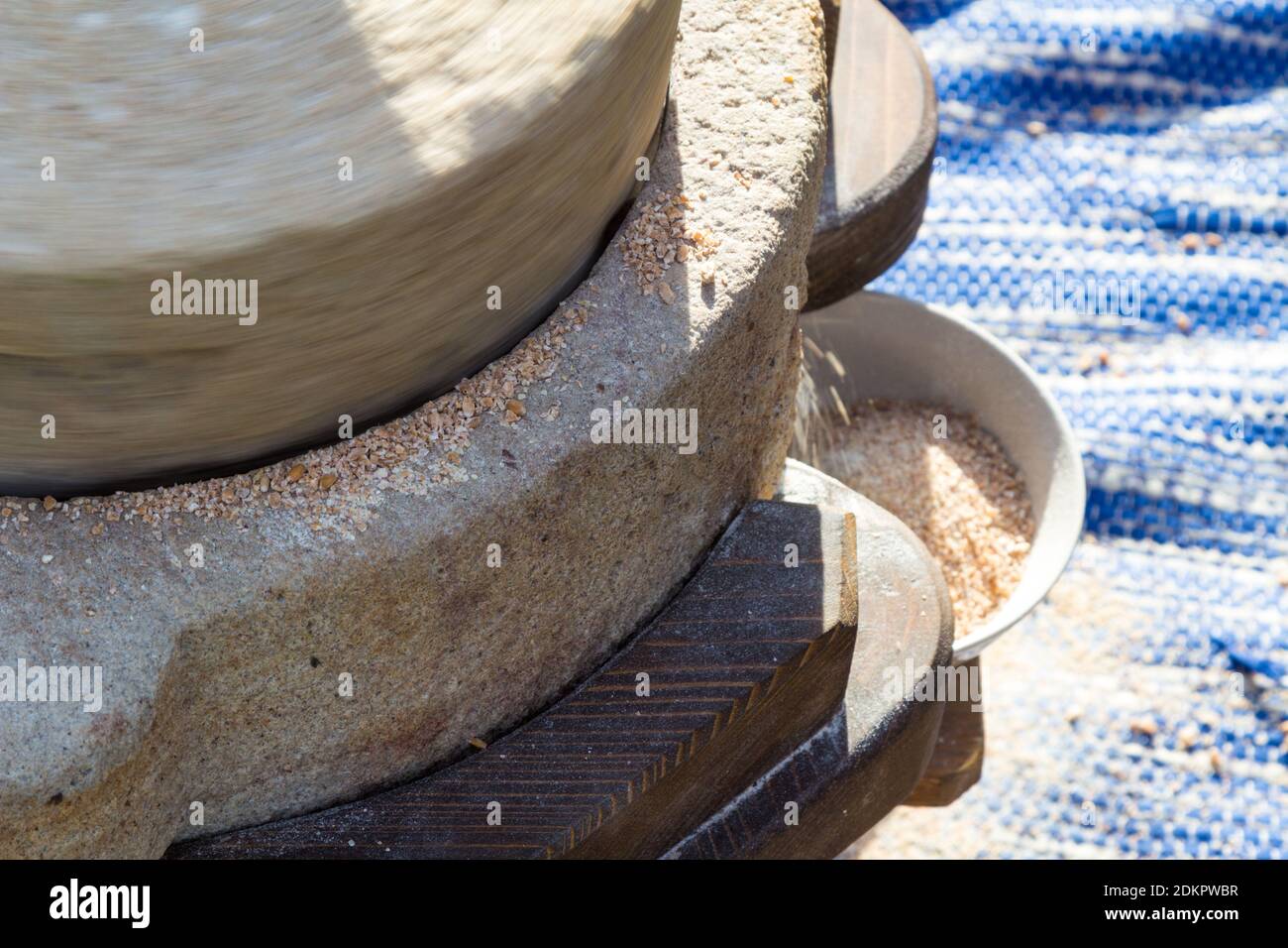 Close-up of hand operated millstone grinding wheat Stock Photo