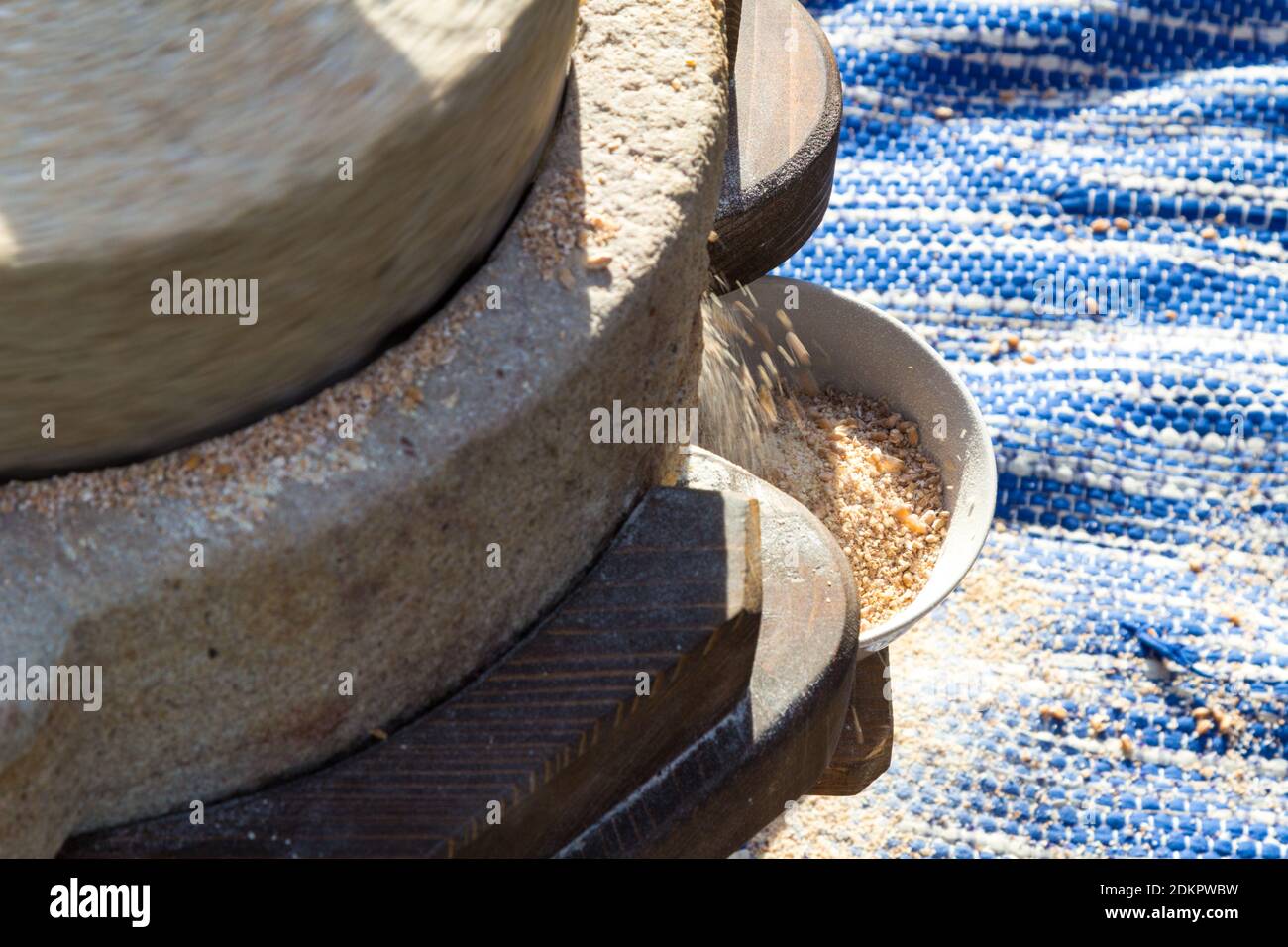 Close-up of hand operated millstone grinding wheat Stock Photo