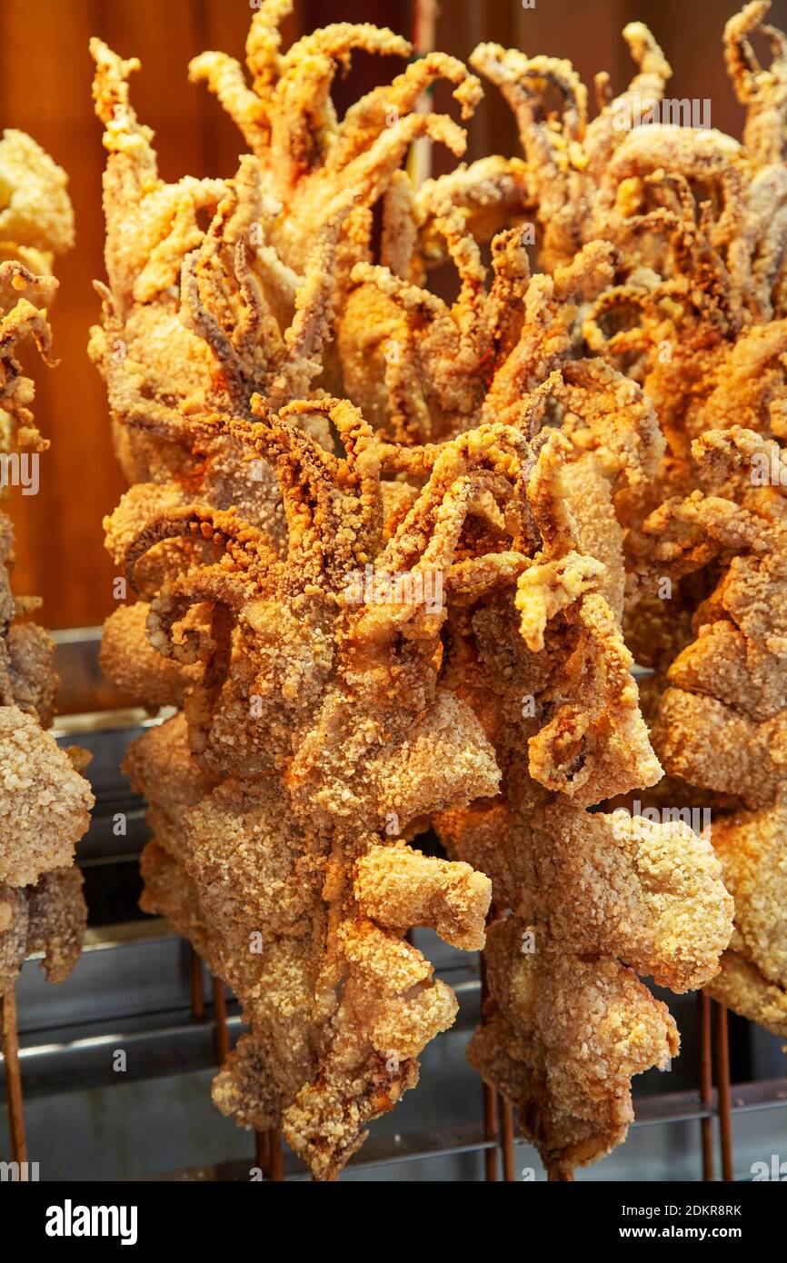 Whole deep fried squid on stick for sale at shop in Muslim Quarter Xian Xi'an China Stock Photo