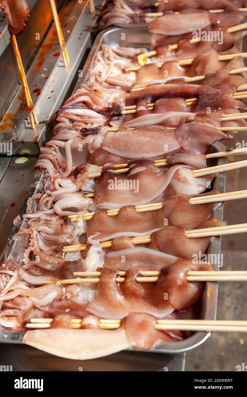 Whole squid on stick before deep frying and being put for sale at shop in Muslim Quarter Xian Xi'an China Stock Photo